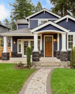 eagle-mortage-home-loans a beautiful blue and white house with a green lawn