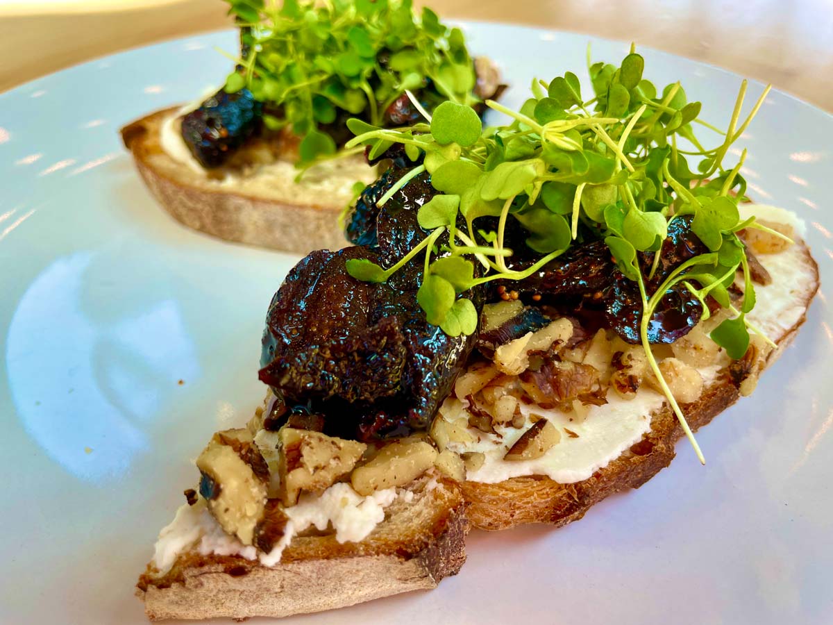 toast with figs. ricotta chèvre spread topped with balsamic and sprouts