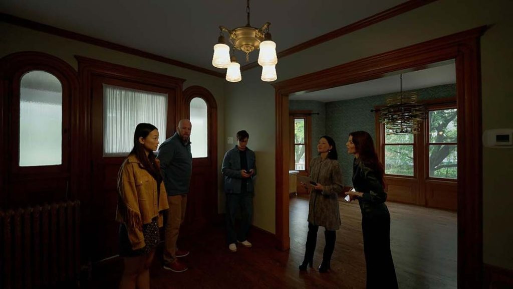 A real estate agent shows the house to the family
