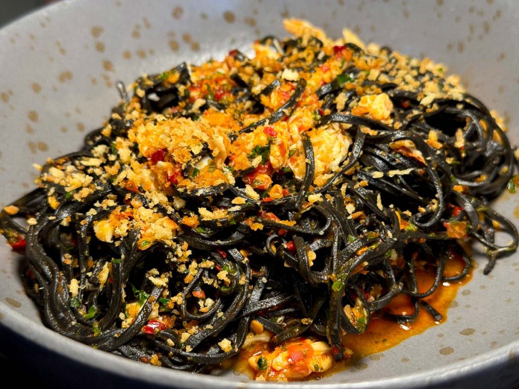 Squid ink taglierini and crab