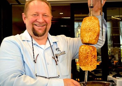 Alceu Pressi, managing partner with grilled pineapple (abacaxi)