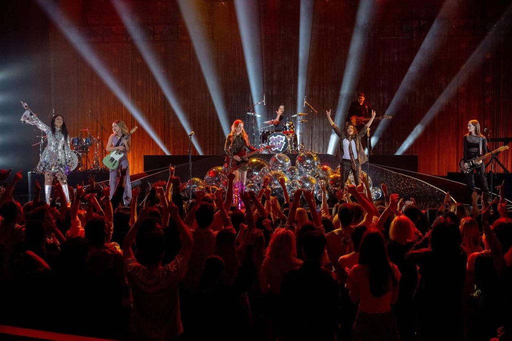 The Pink Slips perform on stage at a fictional concert